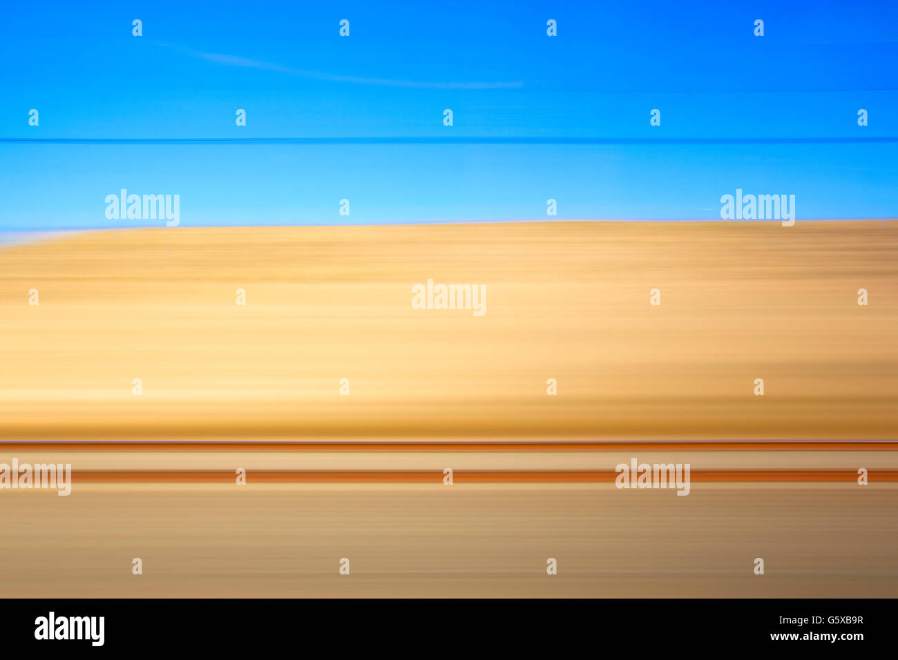 Yellow and blue landscape view from a train. Horizontal format Stock ...