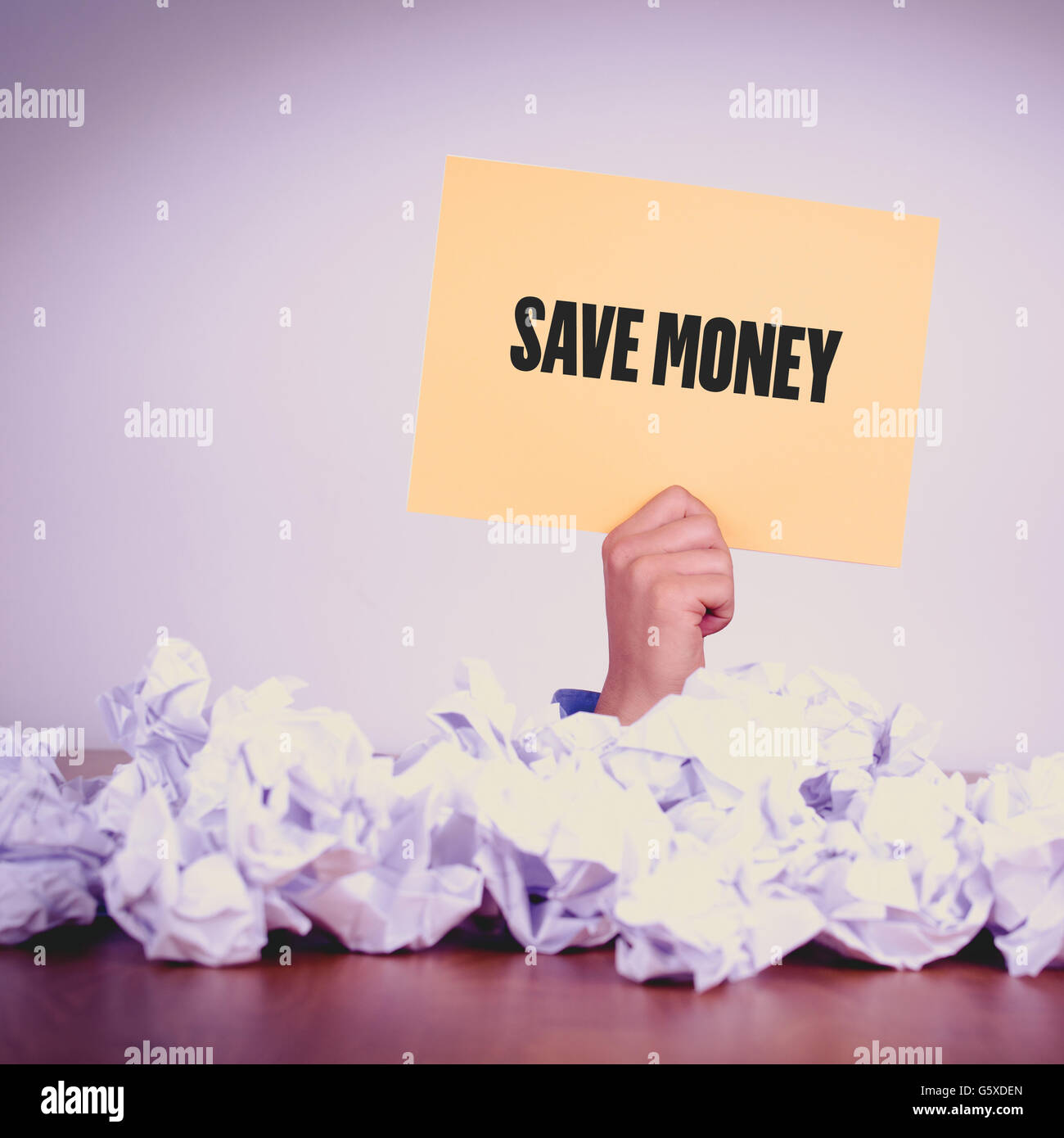 HAND HOLDING YELLOW PAPER WITH SAVE MONEYCONCEPT Stock Photo