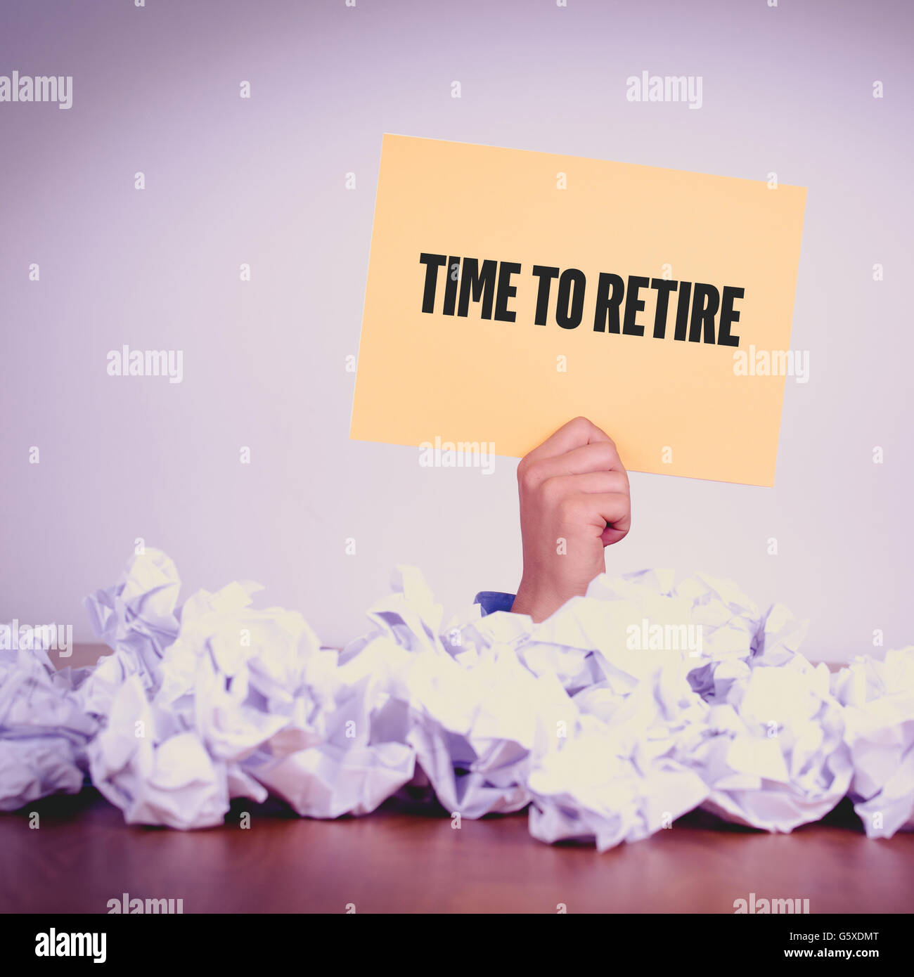 HAND HOLDING YELLOW PAPER WITH TIME TO RETIRECONCEPT Stock Photo
