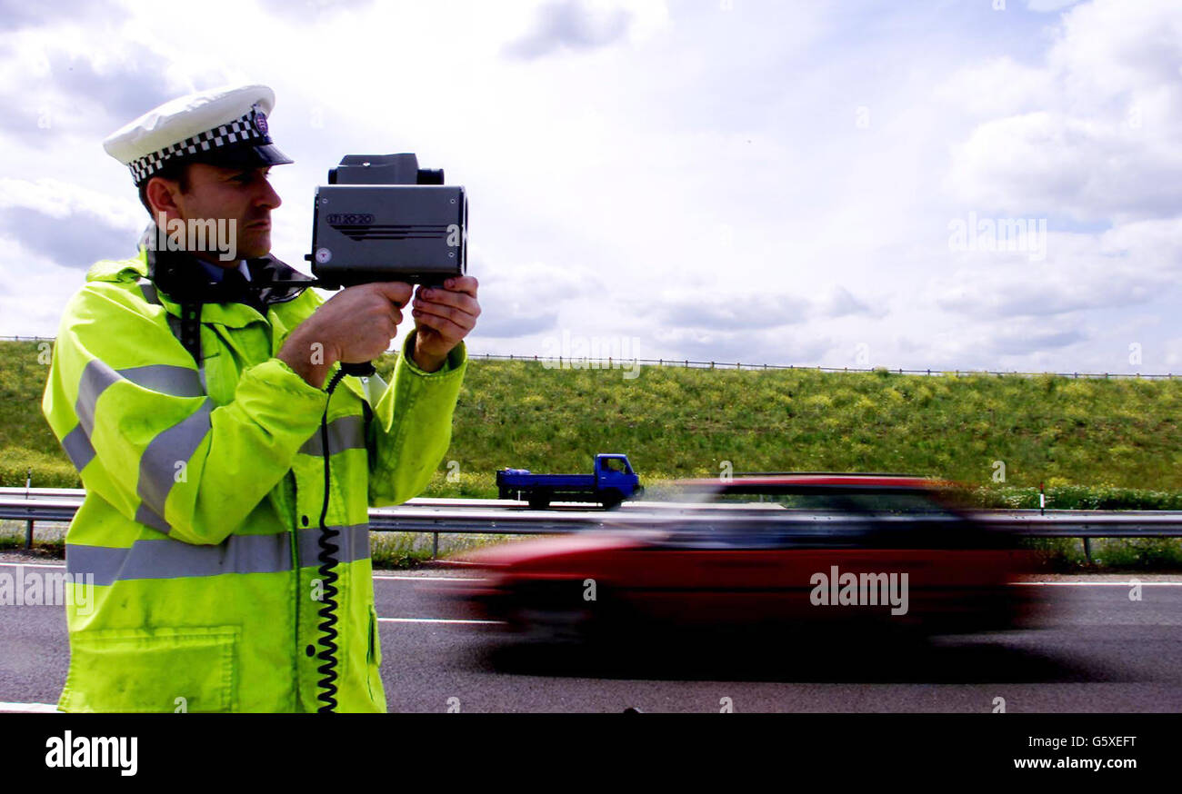 Sgt Paul Moor from Essex Traffic Police uses a laser speed gun on the new stretch of the A130 between Chelmsford and Southend. Forty motorists who drove above 100mph on the new road are appearing at a special court hearing at Witham Magistrates Court. Stock Photo