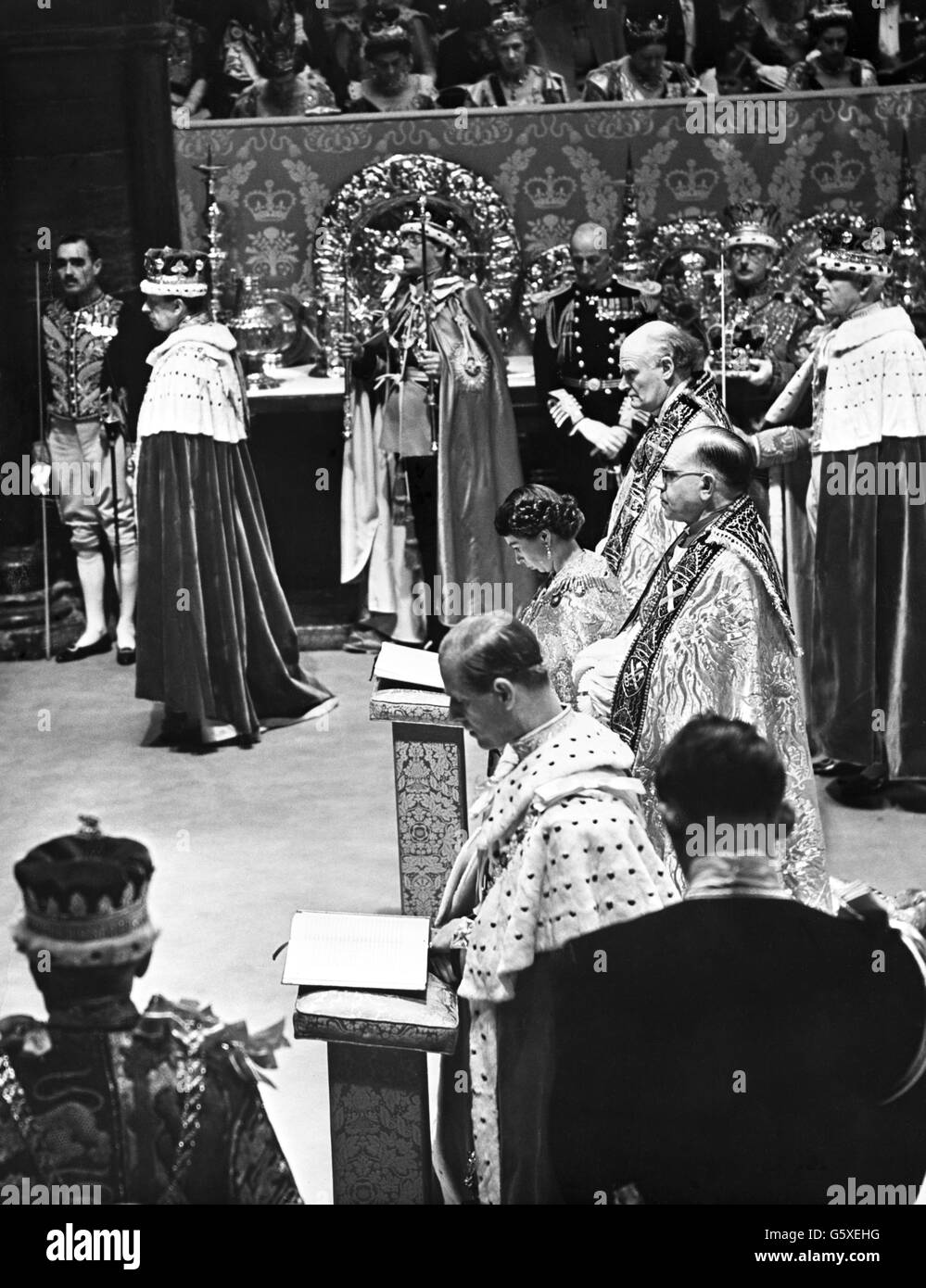 The Queen and the Duke of Edinburgh kneeling side by side in front of the Altar for the Communion in Westminster Abbey after the Crowning and Homage Ceremonies. Stock Photo