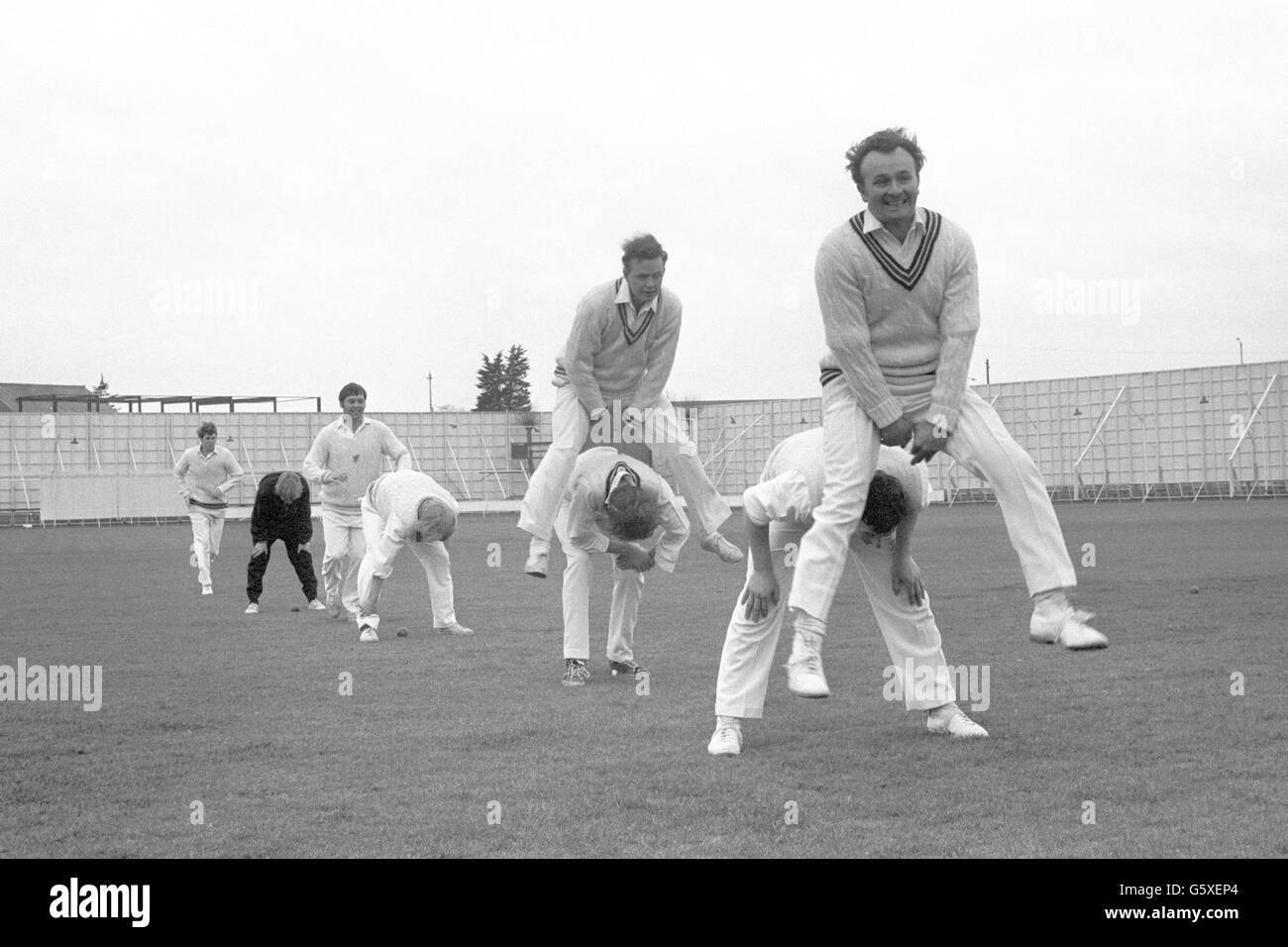 Somerset captain Brian Langford, foreground on right, leap-frogs over a team-mate during a training session at County Cricket ground at Taunton. Stock Photo
