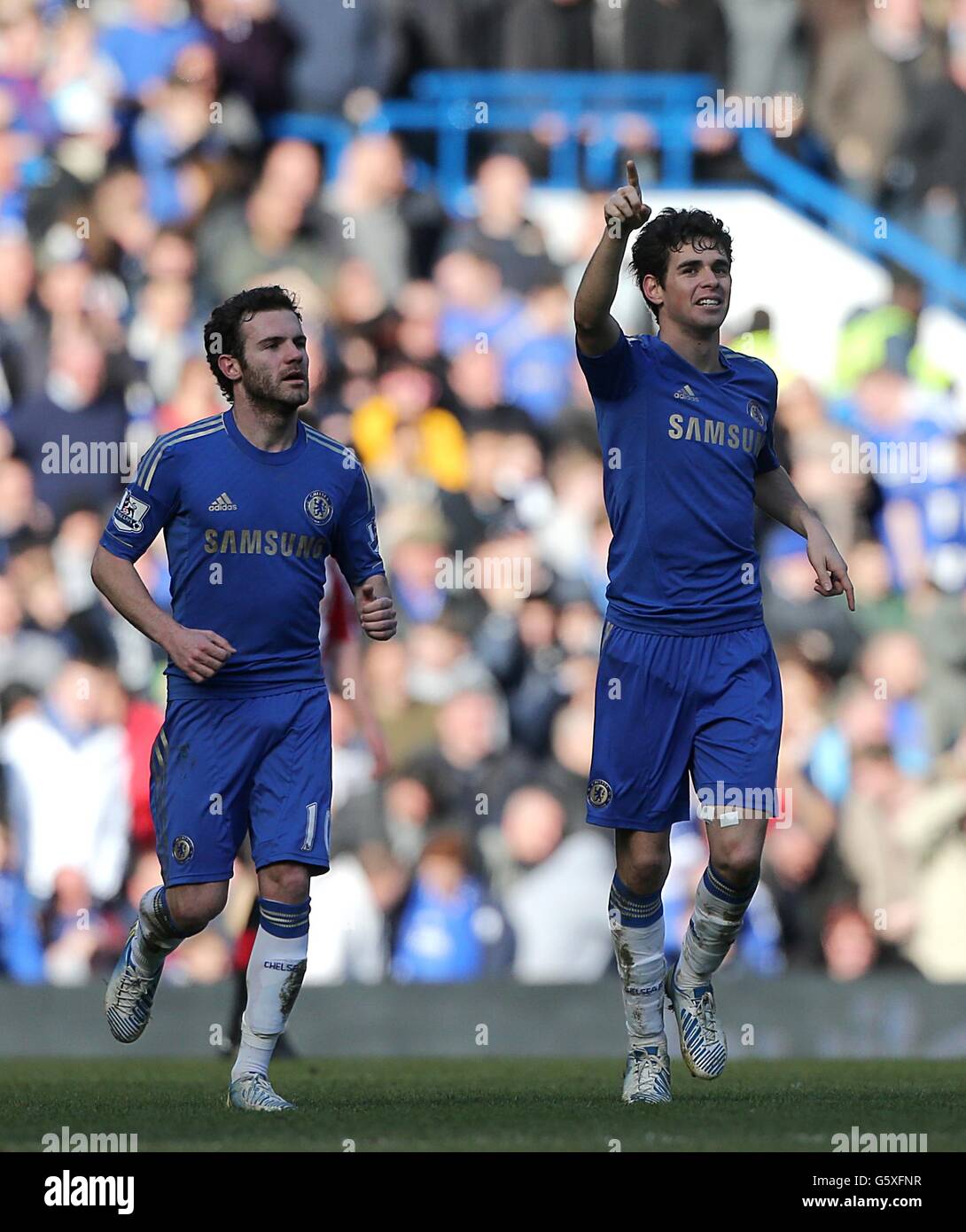 Chelsea's Emboaba Oscar (right) celebrates scoring his side's second goal of the game with teammate Juan Mata (left) Stock Photo