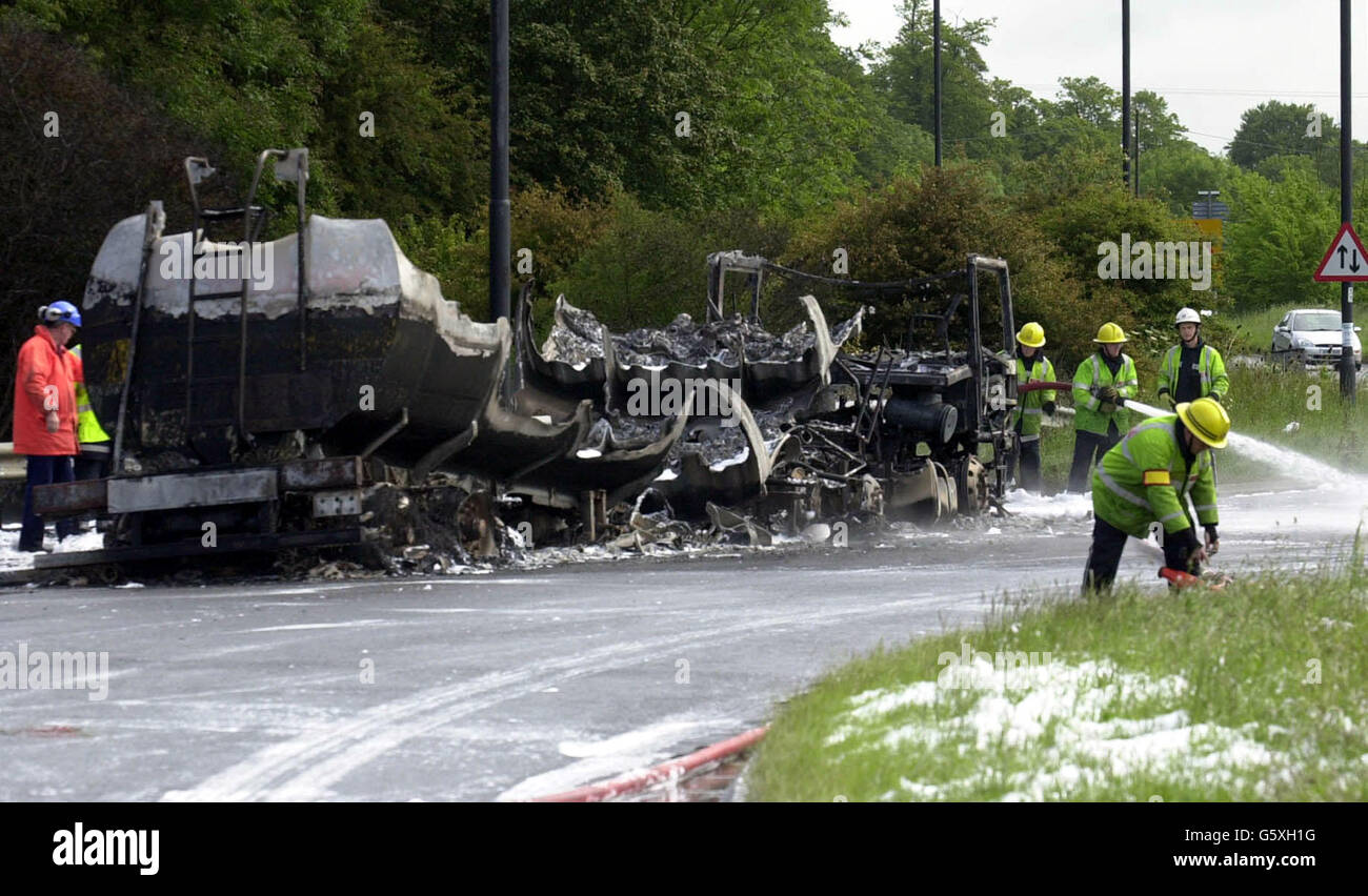 Emergency services attending the scene of the petrol tanker explosion. Traffic was thrown into chaos on a busy motorway junction today when a tanker containing 30,000 litres of petrol caught fire. * The tanker overturned and caught fire just before 7am on a roundabout above junction 18 of the M4 at Tormarton near Bristol at the Bath turn-off. The driver of the tanker immediately got out of his vehicle and was uninjured but the fire sent smoke billowing 100ft in the air. Stock Photo