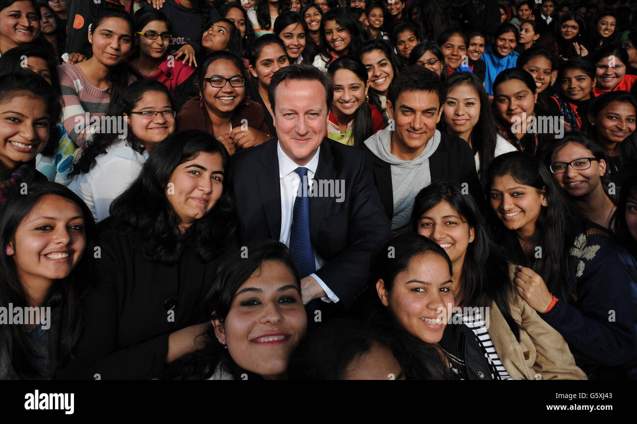Prime Minister David Cameron poses with Bollywood superstar Aamir Khan (right) as he meets students at Janki Devi Memorial College, a girls only college, in Delhi, India during the second day of a three day visit to the country. Stock Photo