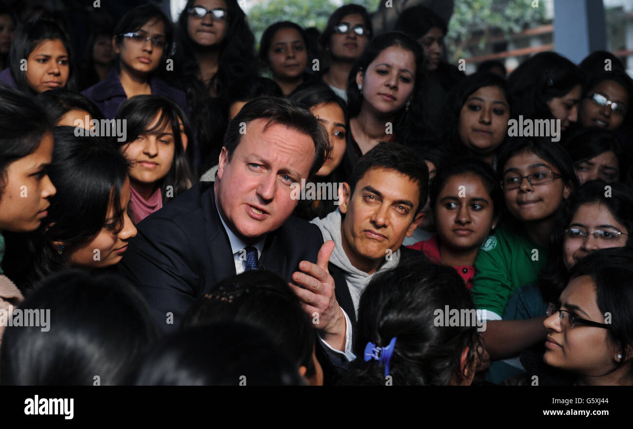 Prime Minister David Cameron poses with Bollywood superstar Aamir Khan (right) as he meets students at Janki Devi Memorial College, a girls only college, in Delhi, India during the second day of a three day visit to the country. Stock Photo