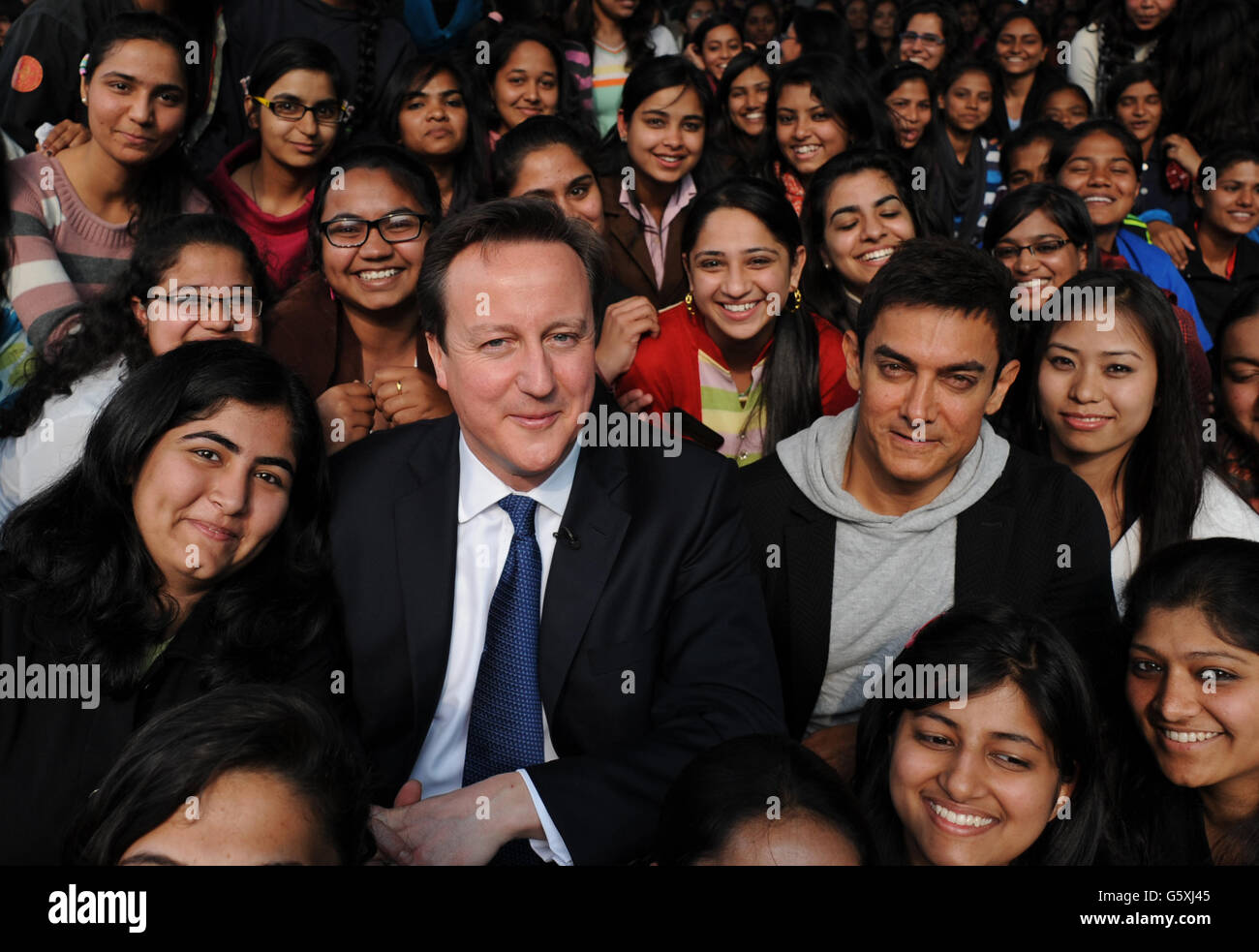 Prime Minister David Cameron poses with Bollywood superstar Aamir Khan (right) as he meets students at Janki Devi Memorial College, a girls only college, in Delhi, India during the second day of a three day visit to the country. Stock Photo