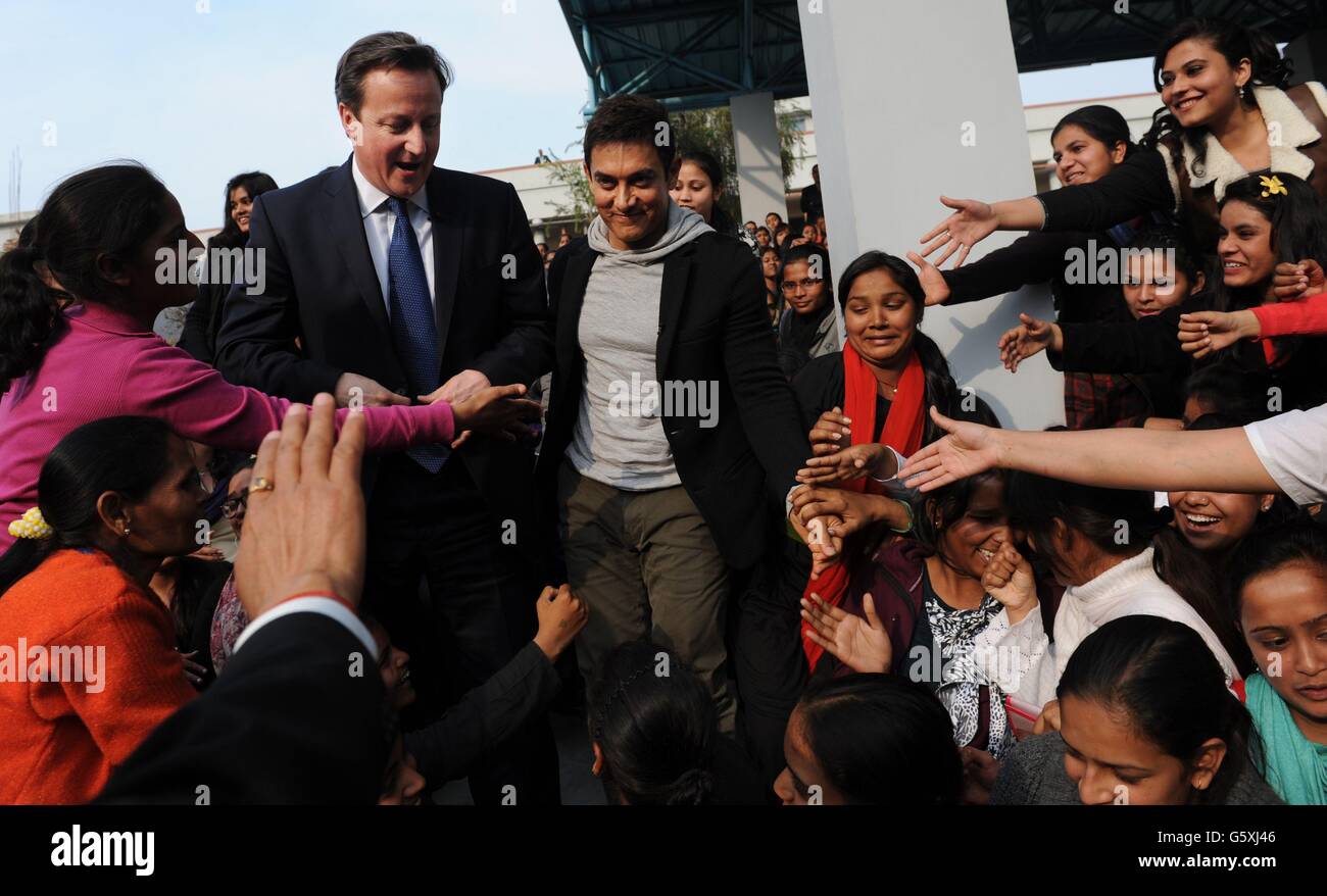 Prime Minister David Cameron with Bollywood superstar Aamir Khan (right) as he meets students at Janki Devi Memorial College, a girls only college, in Delhi, India during the second day of a three day visit to the country. Stock Photo