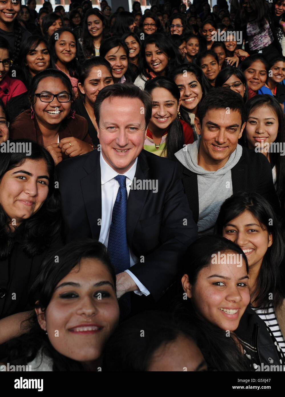 Prime Minister David Cameron poses with Bollywood superstar Aamir Khan (right) as he meets students at Janki Devi Memorial College, a girls only college, in Delhi, India during the second day of a three day visit to the country. Stock Photo