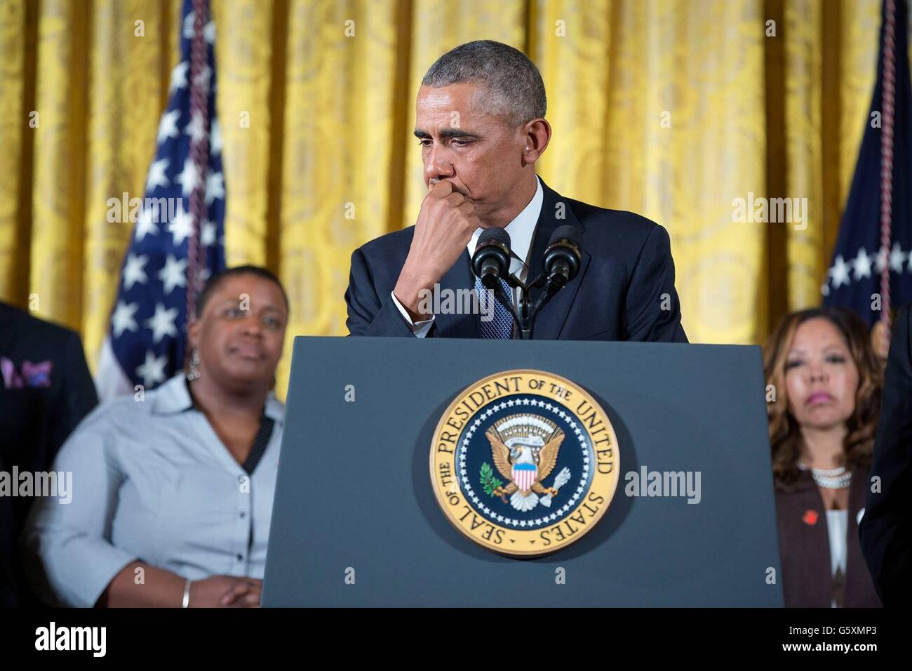 Tears stream down the cheek of U.S President Barack Obama as he discusses the many gun deaths during an announcement of new executive actions to try to reduce gun violence in the East Room of the White House January 5, 2016 in Washington, DC. Stock Photo