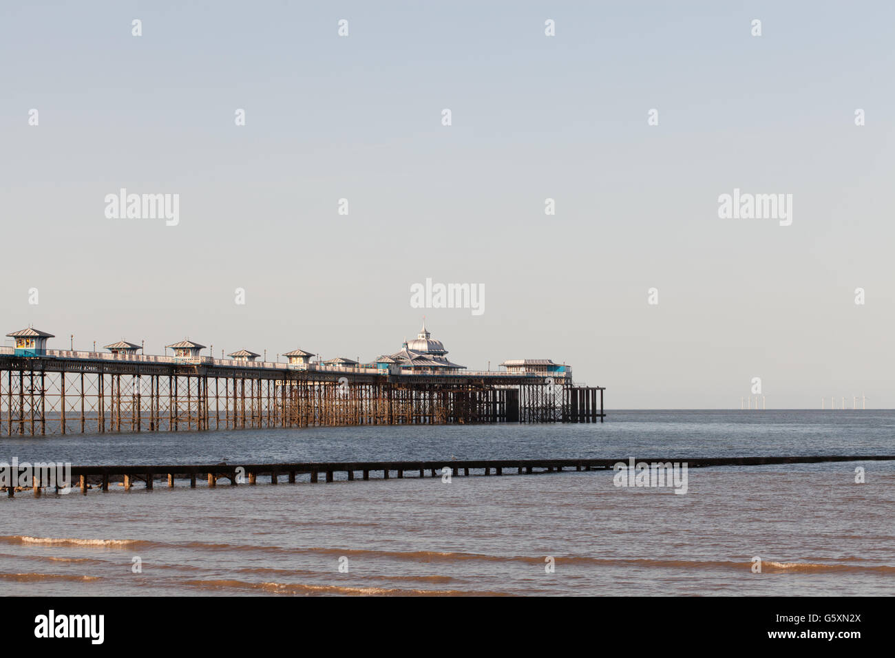 The victorian pier stretching out to sea at Llandudno taken in evening light. Stock Photo