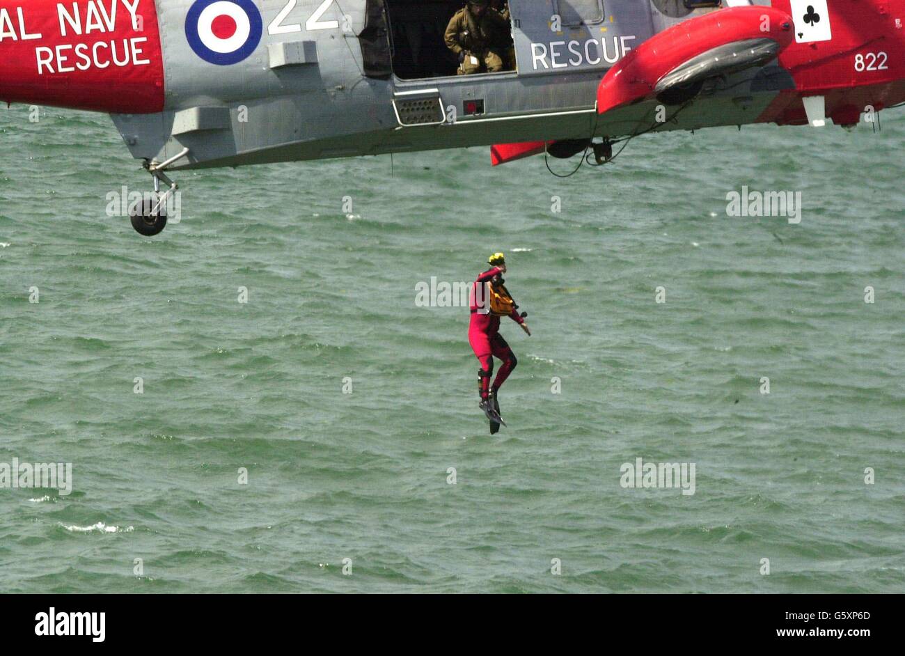 A Royal Navy diver - who sensationally jumped from a hovering helicopter and swam to the Ark Royal to present a posey to Britain's Queen Elizabeth II during the Review of the Fleet on Britain's aircraft carrier The Ark Royal, in Portsmouth. Stock Photo