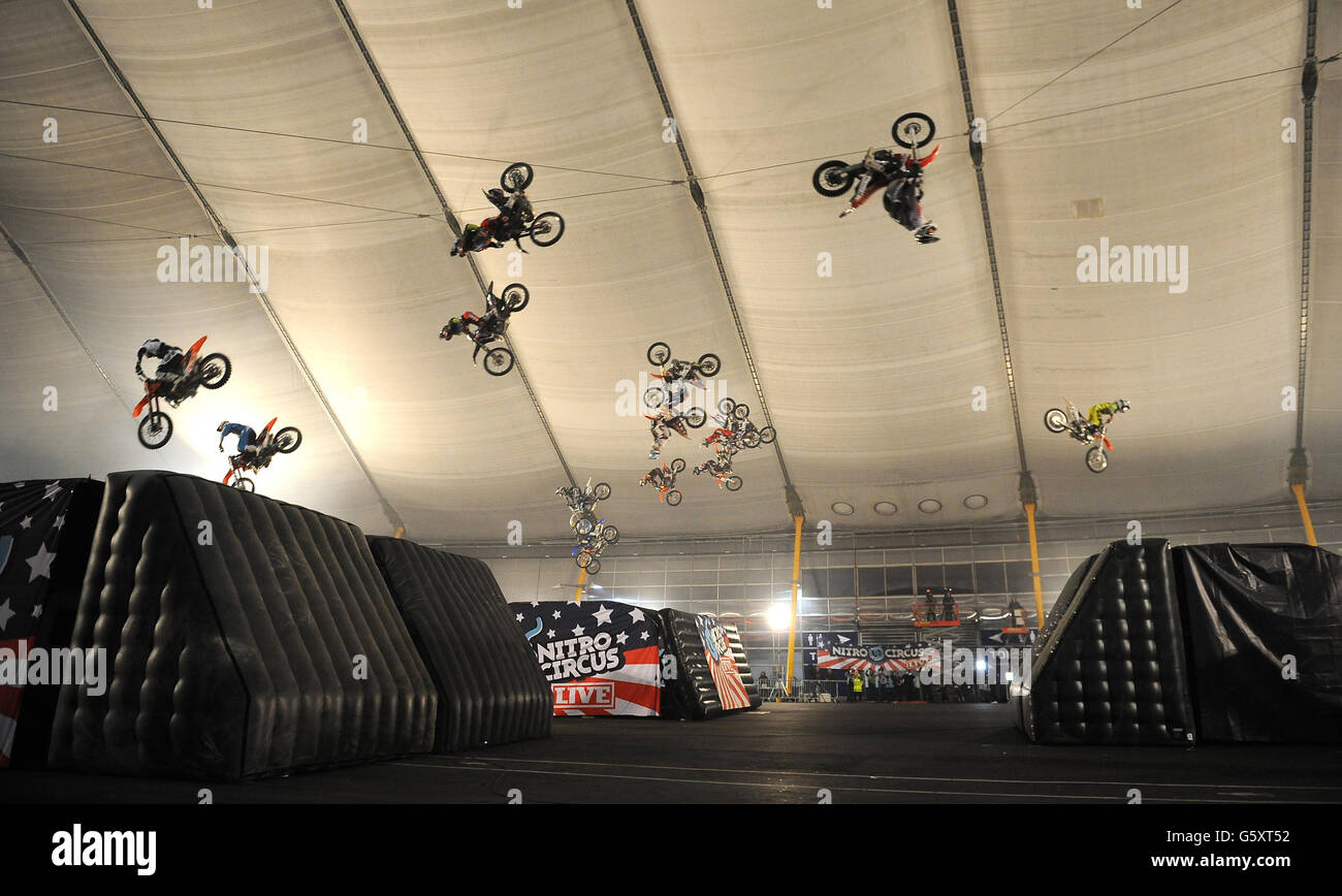 18 motocross riders back flip at the 02 Arena during a Guinness World Record attempt for the greatest number of motor bikes back-flipping-in-the-air-simultaneously. Stock Photo