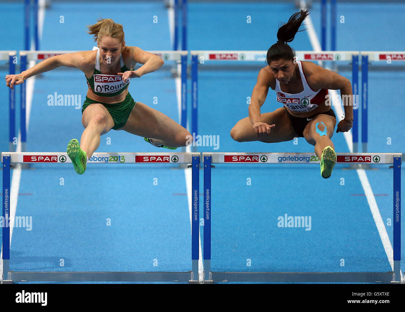 Ireland's Derval O'Rourke (left) competes with Turkey's Nevin Yanit in the womens 60metre hurdles first round during day one of the European Indoor Championships at the Scandinavium Arena, Gothenburg, Sweden. Stock Photo