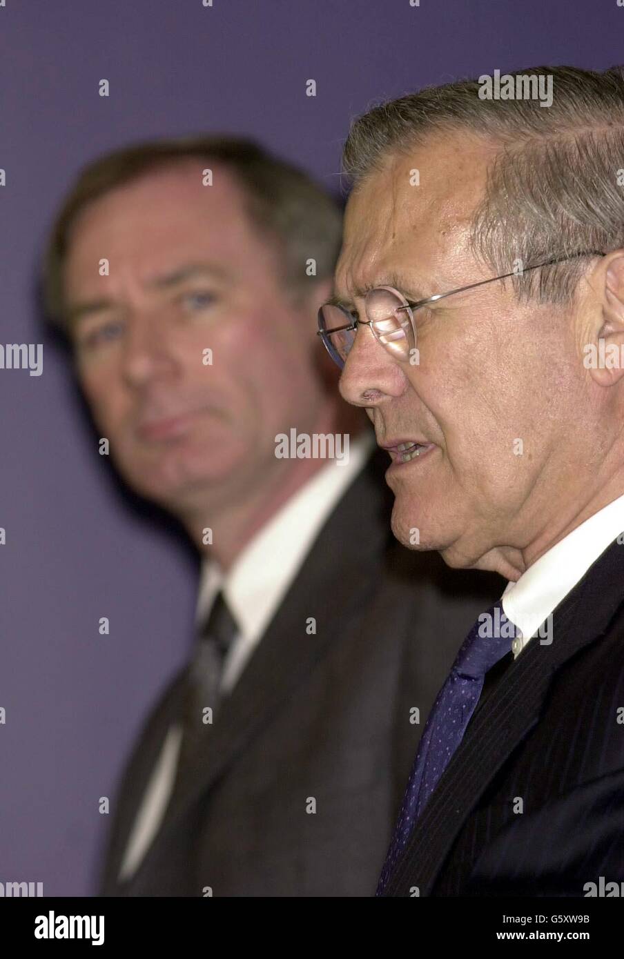 The United States Secretary of Defence Donald Rumsfeld (right) answers a question from a journalist, during a joint press conference with Minister of Defence Geoff Hoon (left), in Whitehall. Stock Photo