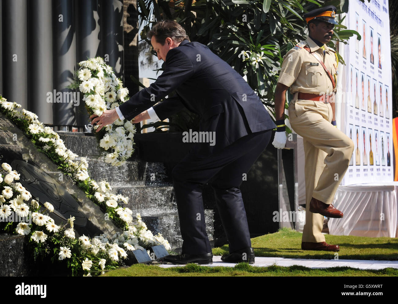 Prime Minister David Cameron lays a wreath at the memorial to commemorate the policemen who were killed in the terrorist attacks of November 2008, in Mumbai, India. Stock Photo