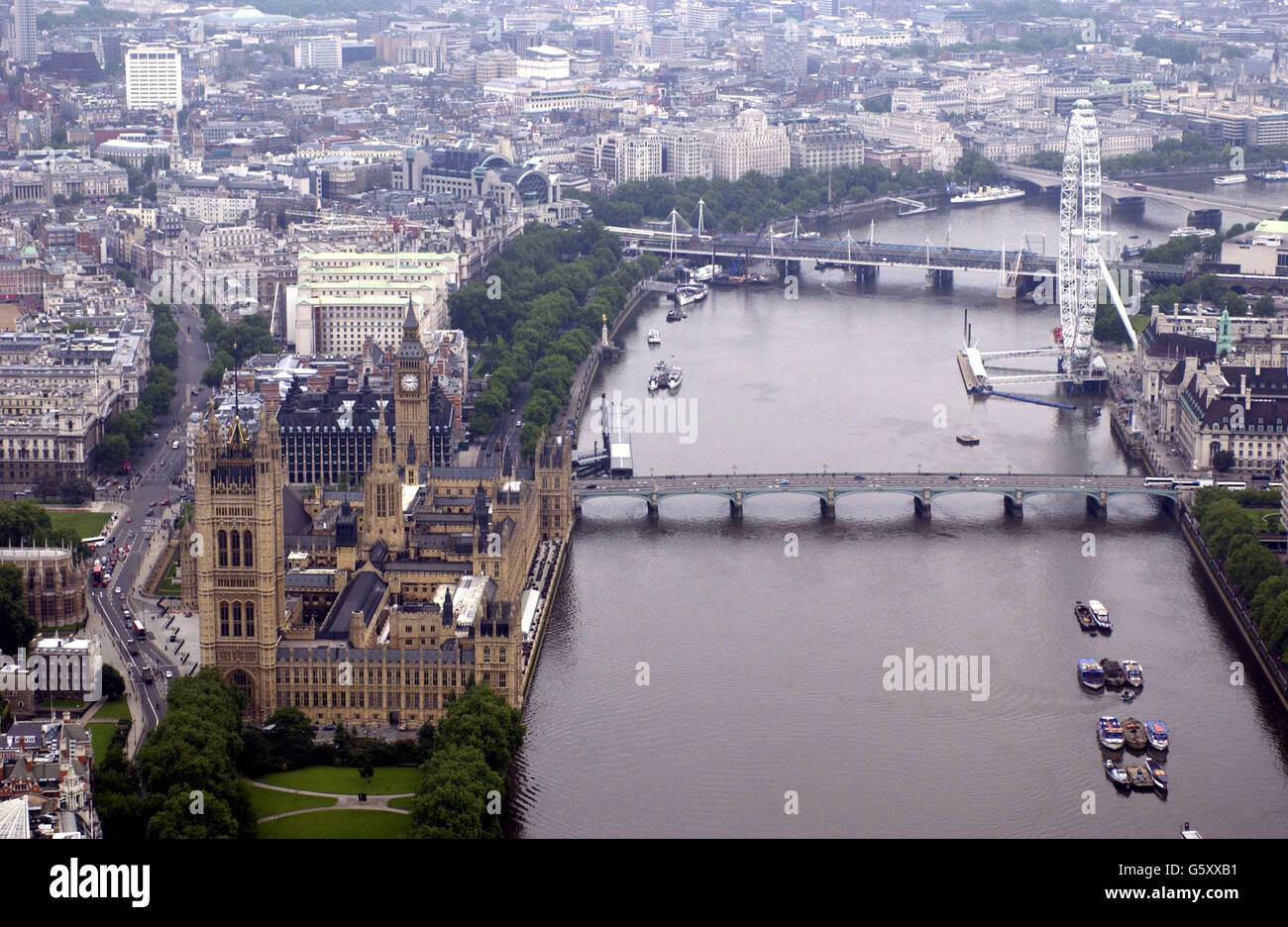 JANUARY 6TH : On this day in 1928 the River Thames burst it's banks drowning 14 people and making hundreds homeless. An aerial view of The Houses of Parliament, The River Thames, and the London Eye. Stock Photo
