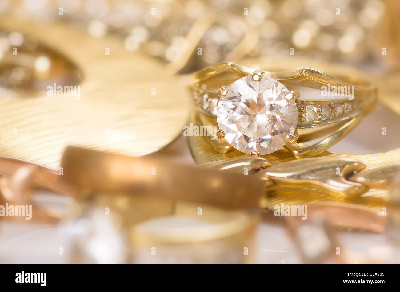 Gold jewelry on a white background Stock Photo - Alamy