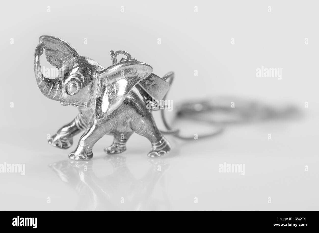 Elephant pendant of silver on a white background. Stock Photo