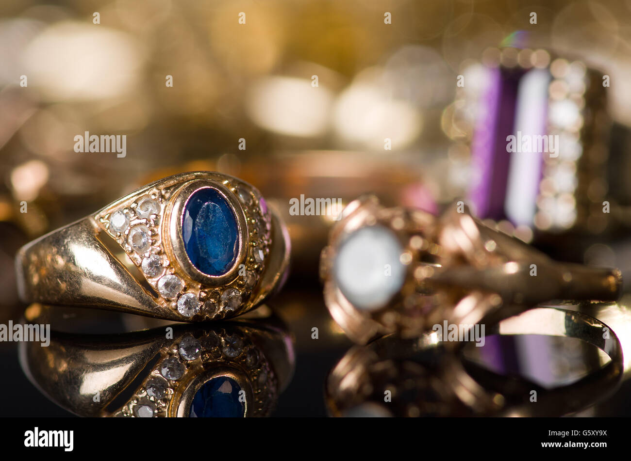 Gold jewelry on a black background Stock Photo Alamy
