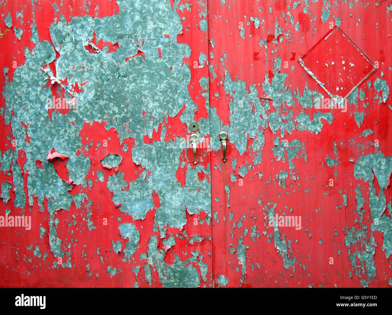 A metal door with red paint that is peeling off Stock Photo Alamy