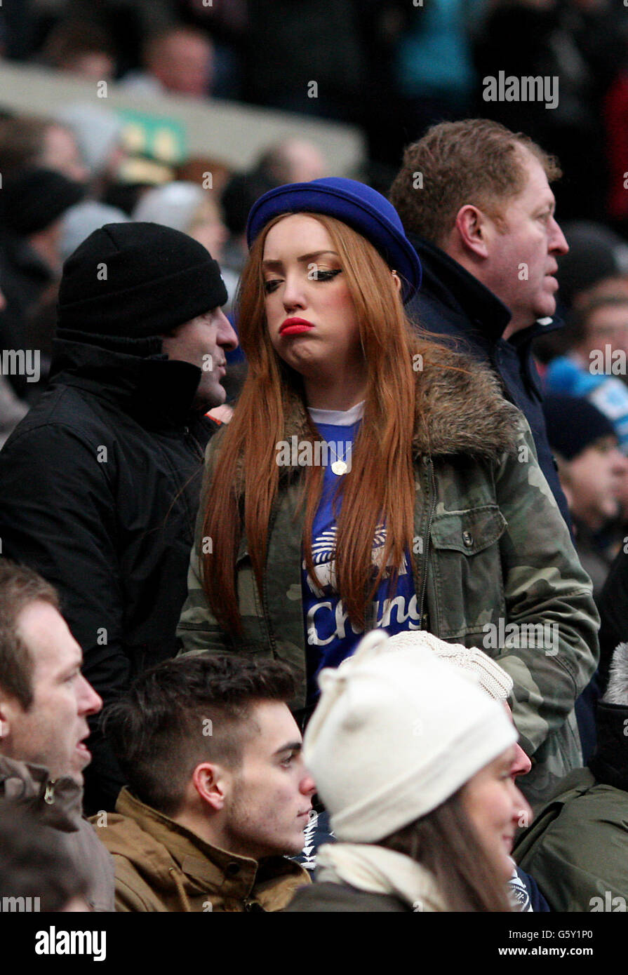 An unhappy Everton fan leaves before the end of the Barclays Premier