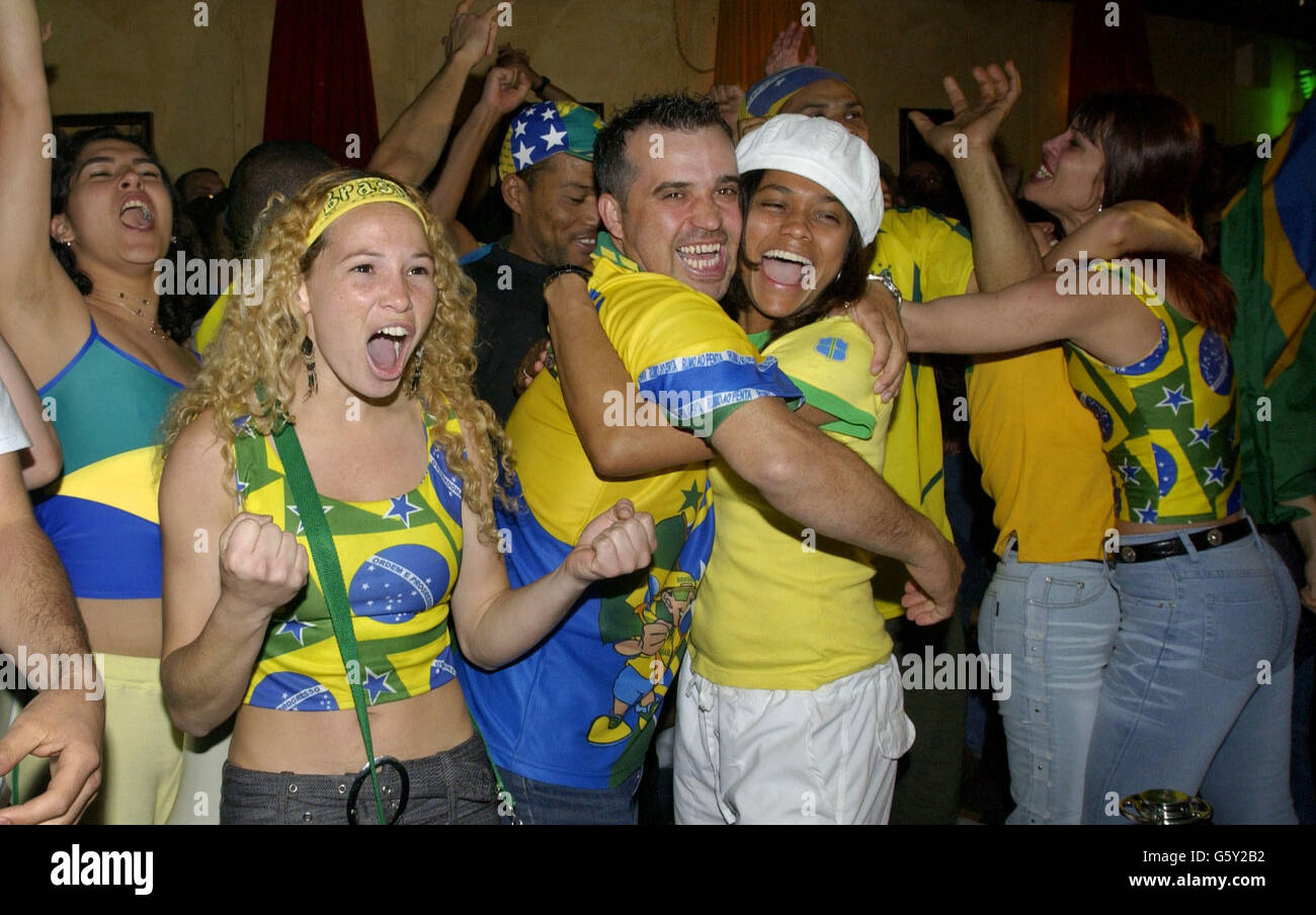 Brazilian Football fans at the Bar Madrid in central London celebrate celebrate their country's 2-1 win against England in the World Cup quarter final in Japan. Stock Photo
