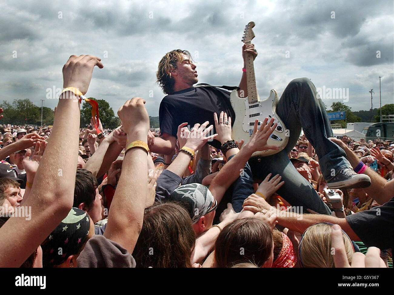 Gavin Rossdale of band, Bush, plays in the crowd at the Glastonbury Festival, at Pilton , Somerset. The festival is a complete sell out, and the weather forecast looks good for the thousands of music fans at the site. * As usual, a huge security operation is in force at the festival, with millions of pounds spent on security fencing to stop non-ticket holders breaking in. Stock Photo