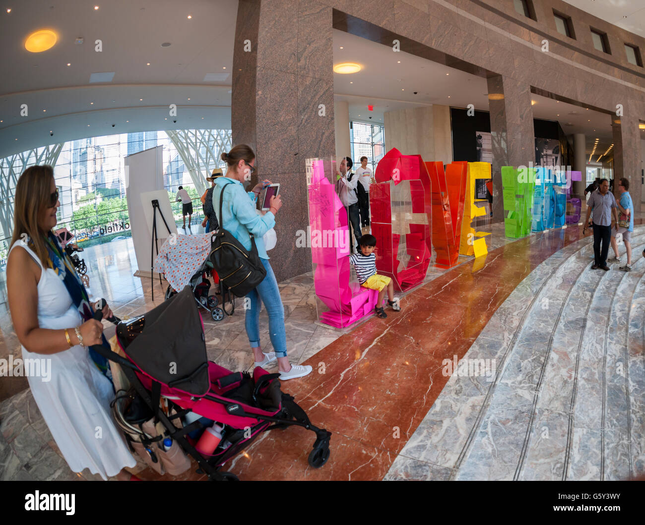 In celebration of Pride Week visitors participate in the 'Love Wins' Letter Project installation in Brookfield Place in New York on Sunday, June 19, 2016. Visitors fill the acrylic letters with with love notes that they have written on a variety of colored papers creating a 'Love Wins' rainbow.  (© Richard B. Levine) Stock Photo