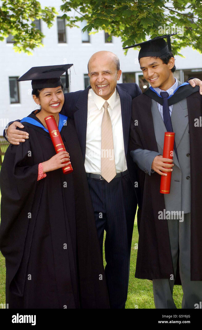 Two of Britain's youngest graduates, brother and sister Iskander, 15, (right) and Noraisha Yusof, 19, with their father Farooq as they graduate from Warwick University with first-class degree with honours and 2-2 Maths degrees respectively. *... The two siblings made academic history when they became the youngest brother and sister to attend university after being taught at home by their mathematician father and their mother, who is a chemistry researcher. Stock Photo