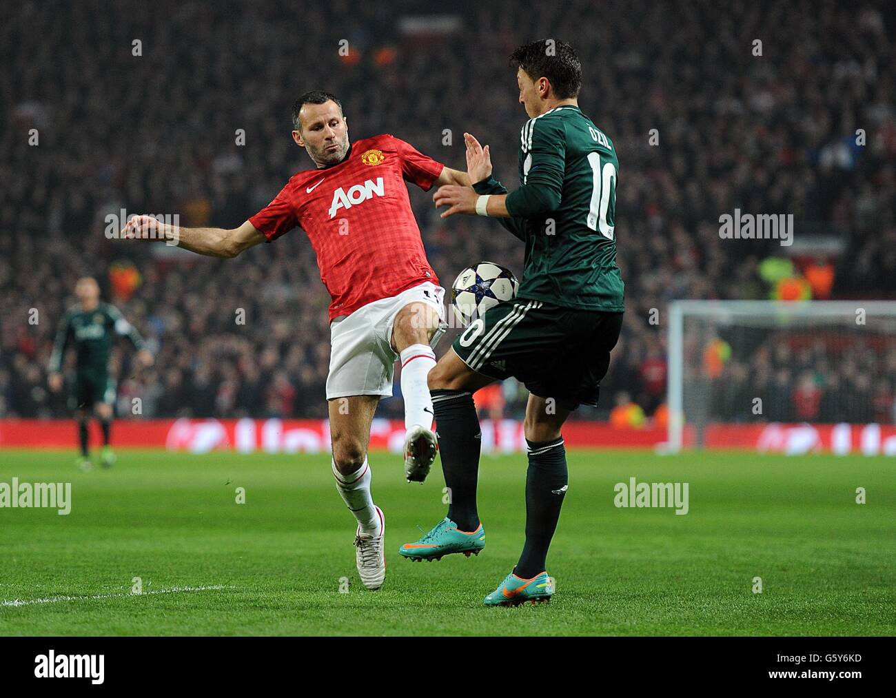 Real Madrid's Mesut Ozil (right) and Manchester United's Ryan Giggs battle for the ball Stock Photo