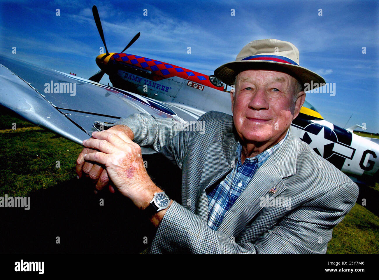 Major General Donald J Strait, former Second World War pilot of the 356th Fighter Group, who shot down 13.5 enemy aircraft, stands in front of a P-51 Mustang at the Flying Legends Airshow, RAF Duxford, Cambridgeshire. Thousands of aviation enthusiasts and families visited the second day of an annual showcase of First and Second World War aircraft, featuring dozens of aircraft, pilots and combat veterans from across the world. Stock Photo