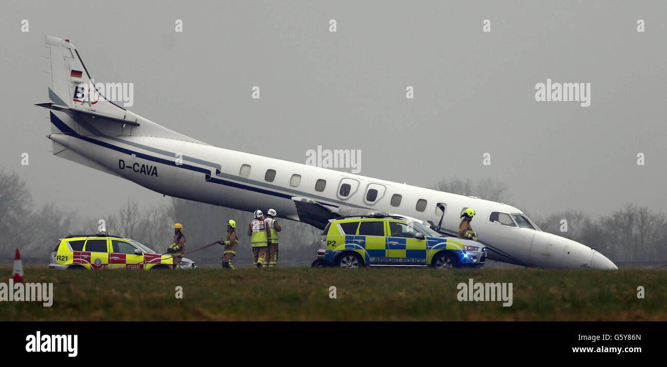 Small plane crashes into car after overshooting runway during