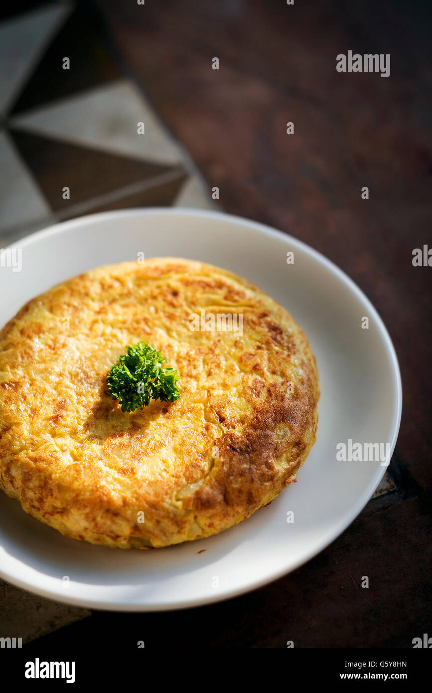 tortilla traditional spanish simple tapas egg omelet on spain rustic style tiles Stock Photo
