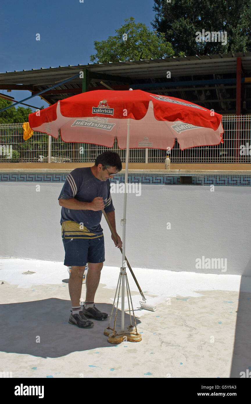 painter painting the bottom of a swimming pool Stock Photo Alamy