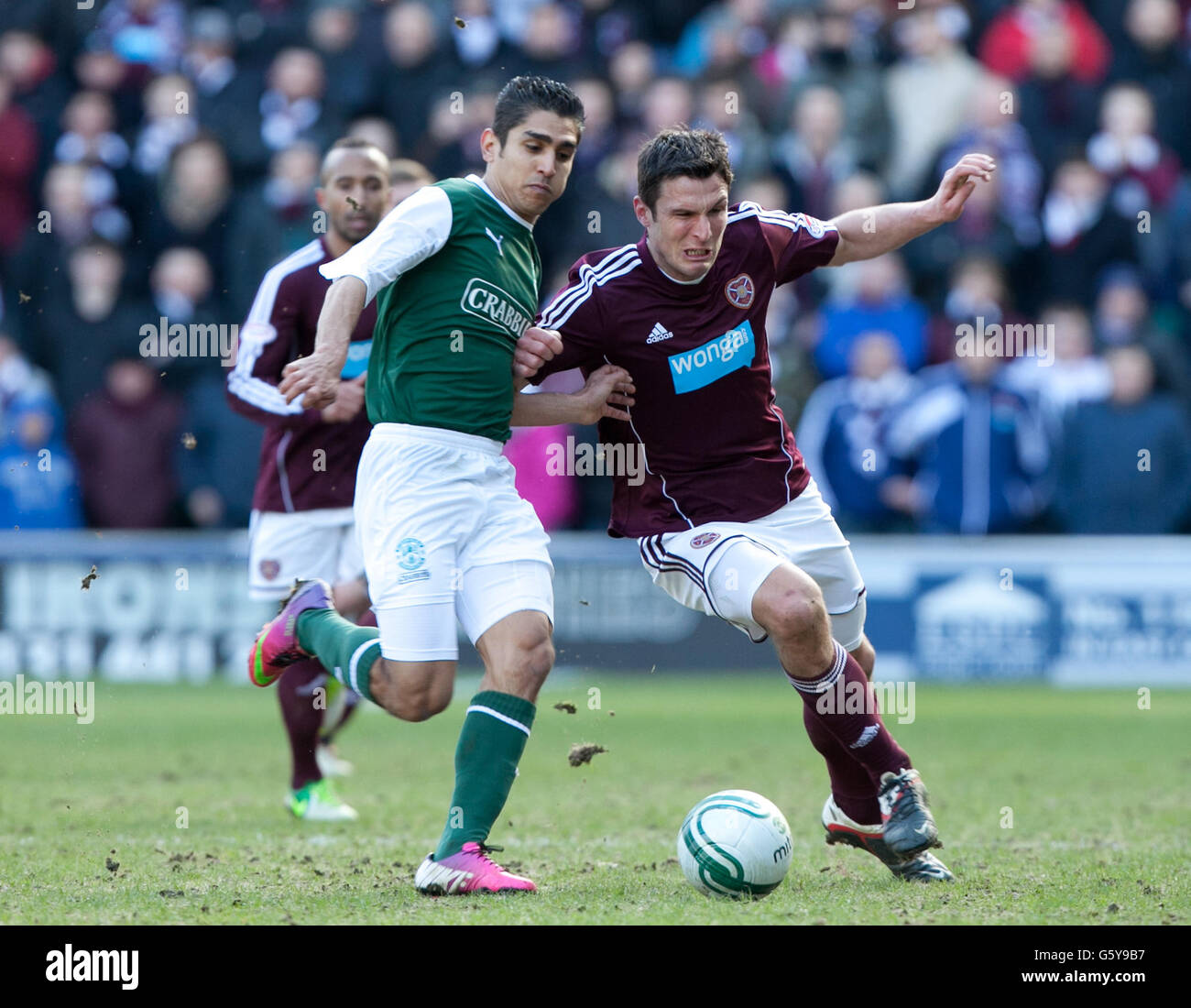 Hibernian's Jorge Claros vies for the ball with Heart of Midlothian's John Sutton (centre) during the Clydesdale Bank Scottish Premier League match at Easter Road, Edinburgh. Stock Photo
