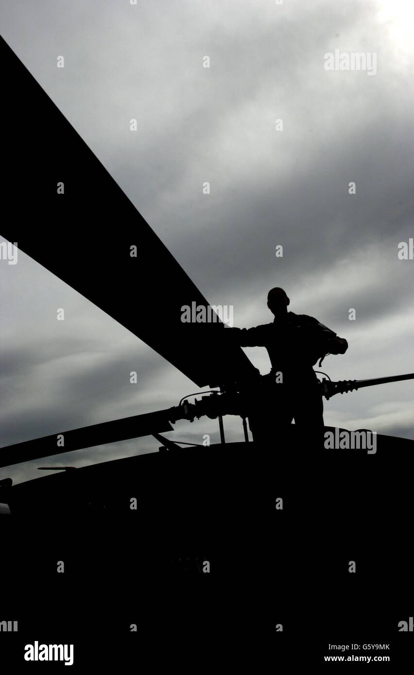 An American Black Hawk helicopter pilot looks over the rota blades at Farnborough Airshow, Hampshire. Stock Photo