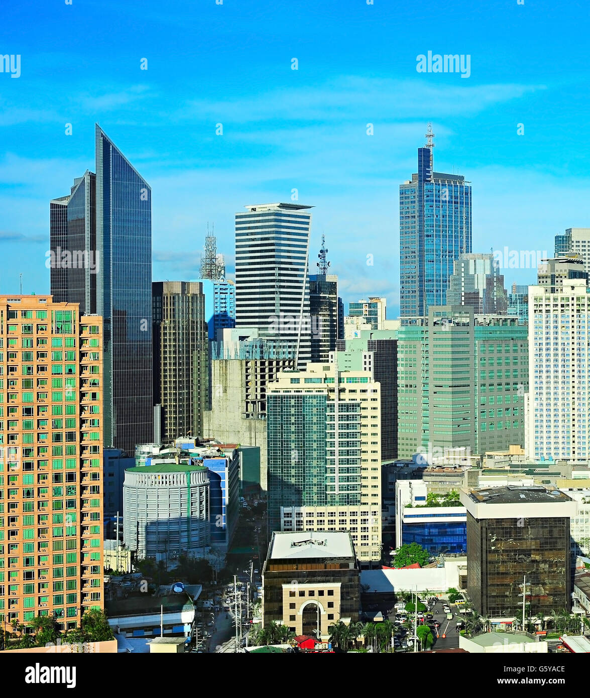 Philippines, Luzon, Manila. Makati business district with Louis Vuitton  advertising board and a rainbow over the city skyline Stock Photo - Alamy