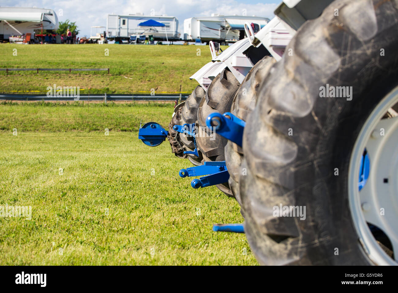 Tractors in perspective.  Antique/Classic farm tractors lined up at show Stock Photo
