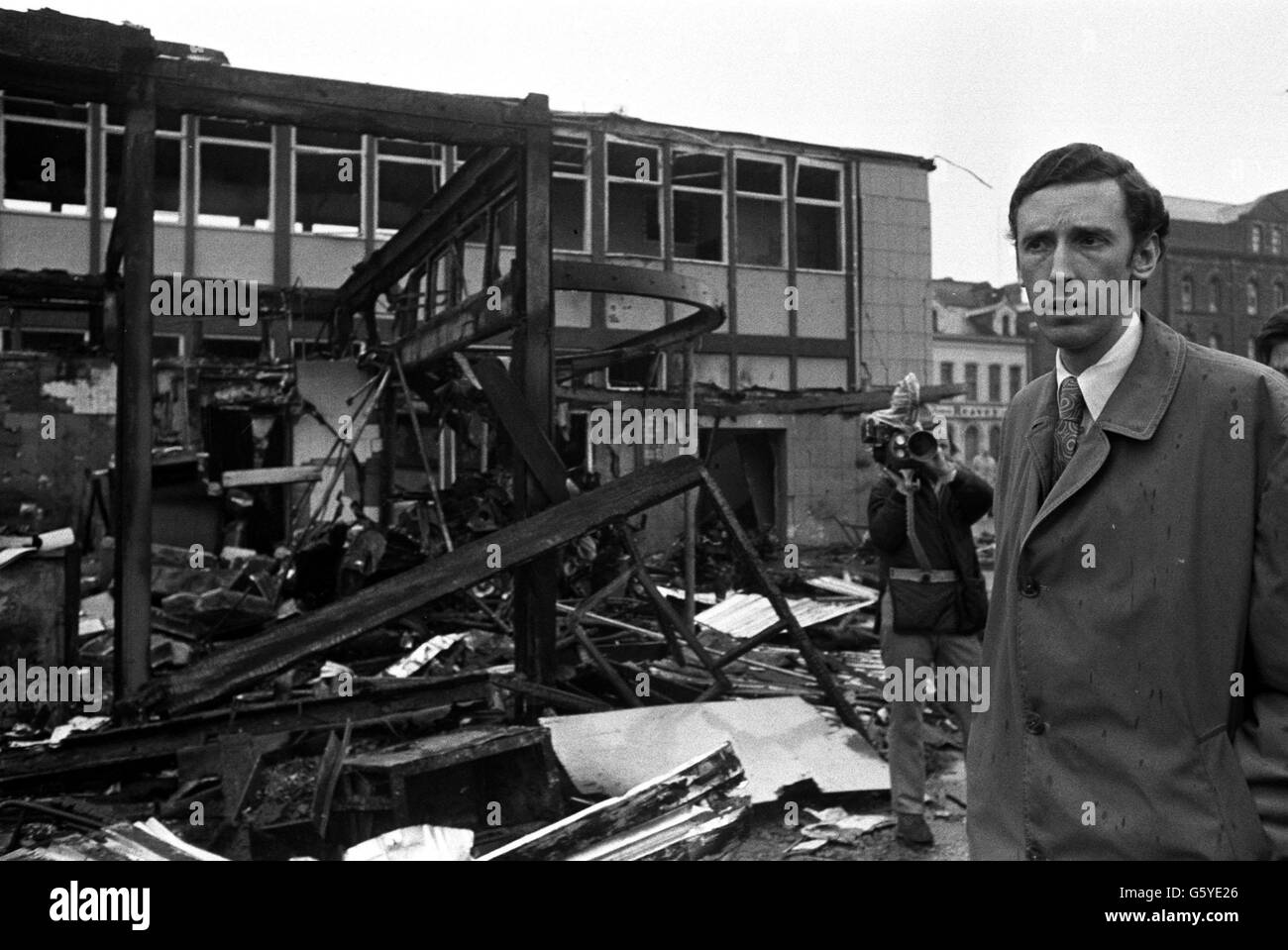 Grim-faced Mr David Howell, Under-Secretary for Northern Ireland, looks at the devastated Oxford Street bus station, scene of one of the blasts in the terrorist bomb blitz in Belfast. *16/07/02 The IRA has apologised to all non-combatants who were killed during 30 years of violence, Tuesday 16 July, 2002. Stock Photo