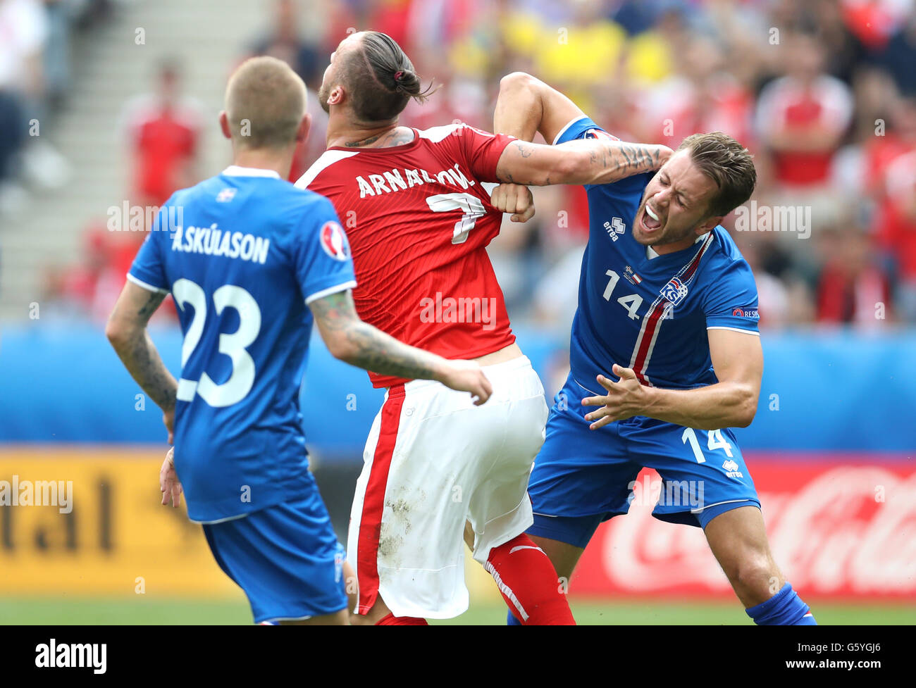 Austria's Marko Arnautovic (centre) and Iceland's Kari Arnason jostle for position during the Euro 2016, Group F match at the Stade de France, Paris. Stock Photo