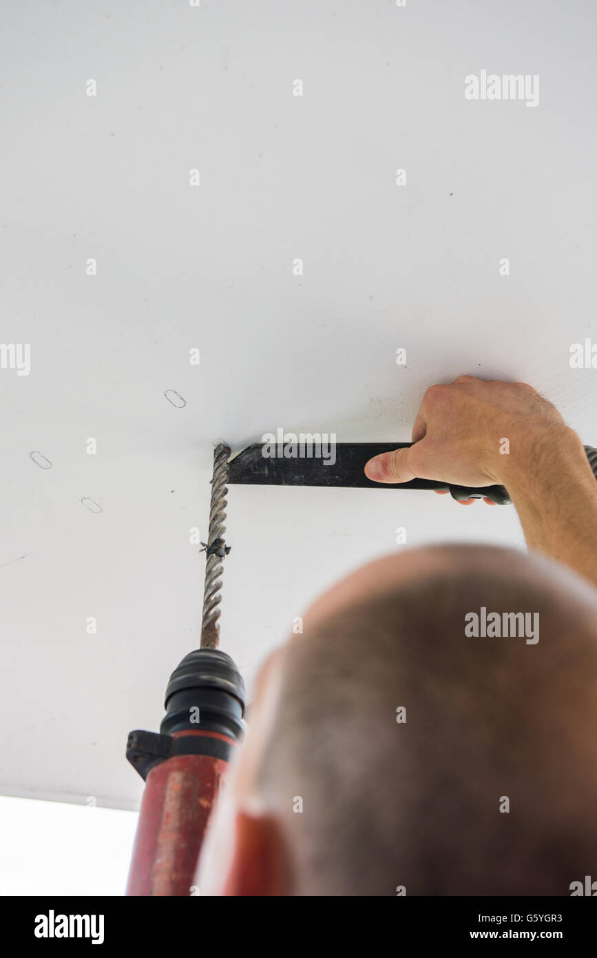 Man Is Drilling Holes Into Concrete Ceiling With Drilling