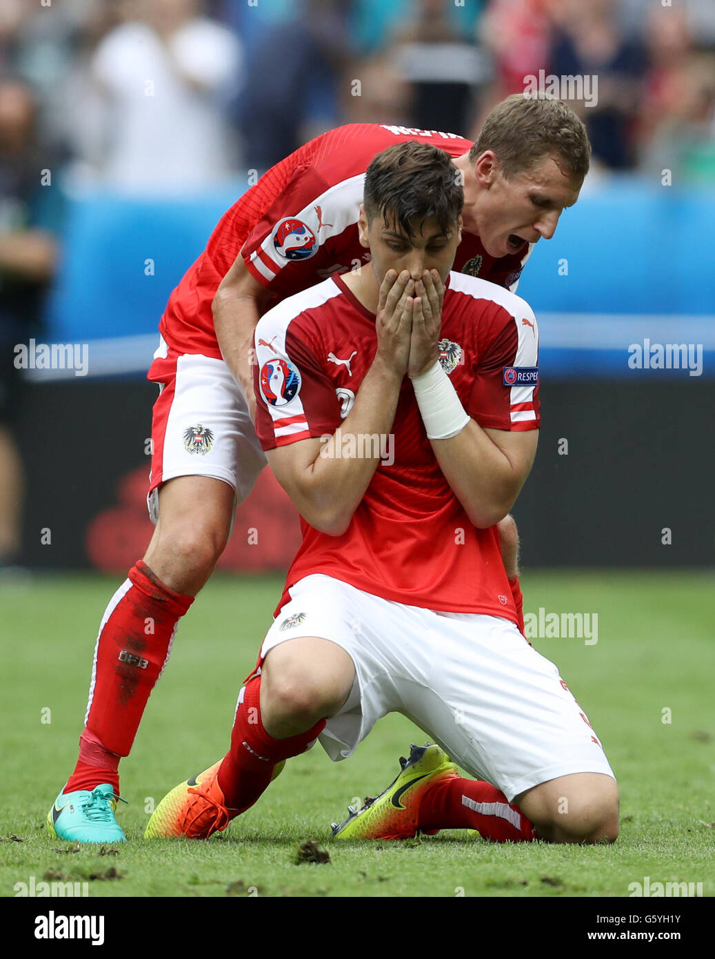 Austria's Aleksandar Dragovic is consoled by teammate Florian Klein (left) after missing a penalty during the Euro 2016, Group F match at the Stade de France, Paris. Stock Photo