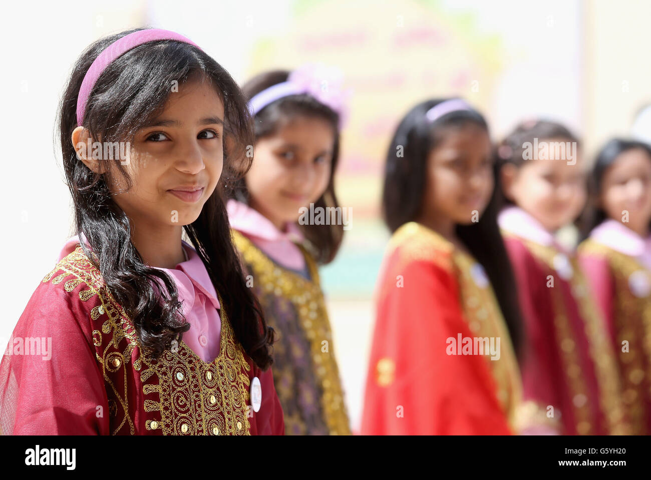 Pupils at the Amna Mahmoud Al Jeddah Primary Independant School for Girls wait for the arrival of the Duchess of Cornwall on day four of the Royal tour to the Middle East in Doha, Qatar. Stock Photo