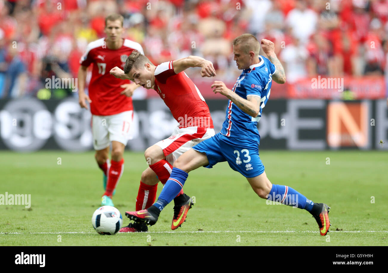 Austria's Marcel Sabitzer (left) and Iceland's Ari Freyr Skulason (right) battle for the ball during the Euro 2016, Group F match at the Stade de France, Paris. Stock Photo