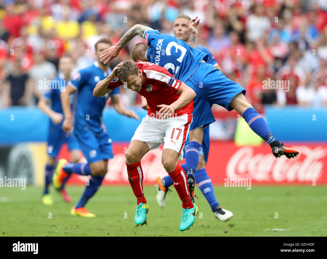 Austria's Florian Klein (left) and Iceland's Ari Freyr Skulason battle for the ball in the air during the Euro 2016, Group F match at the Stade de France, Paris. Stock Photo
