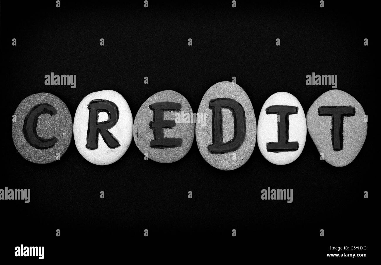 Word Credit spell out from stones with letters on black background. Letters drawn by me Stock Photo