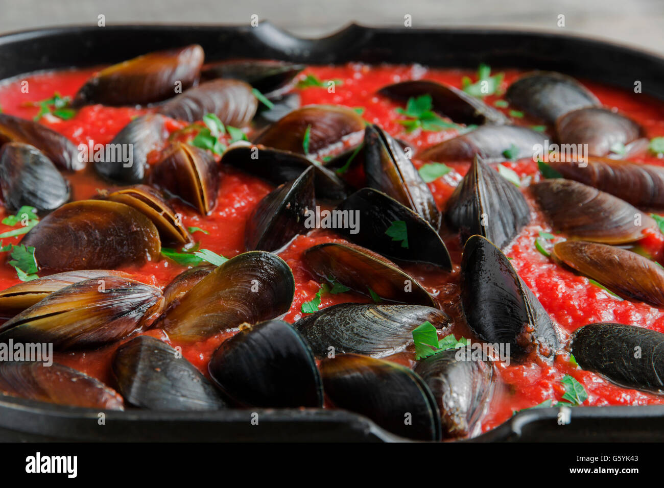 cooking mussel opens in tomato sauce Stock Photo Alamy