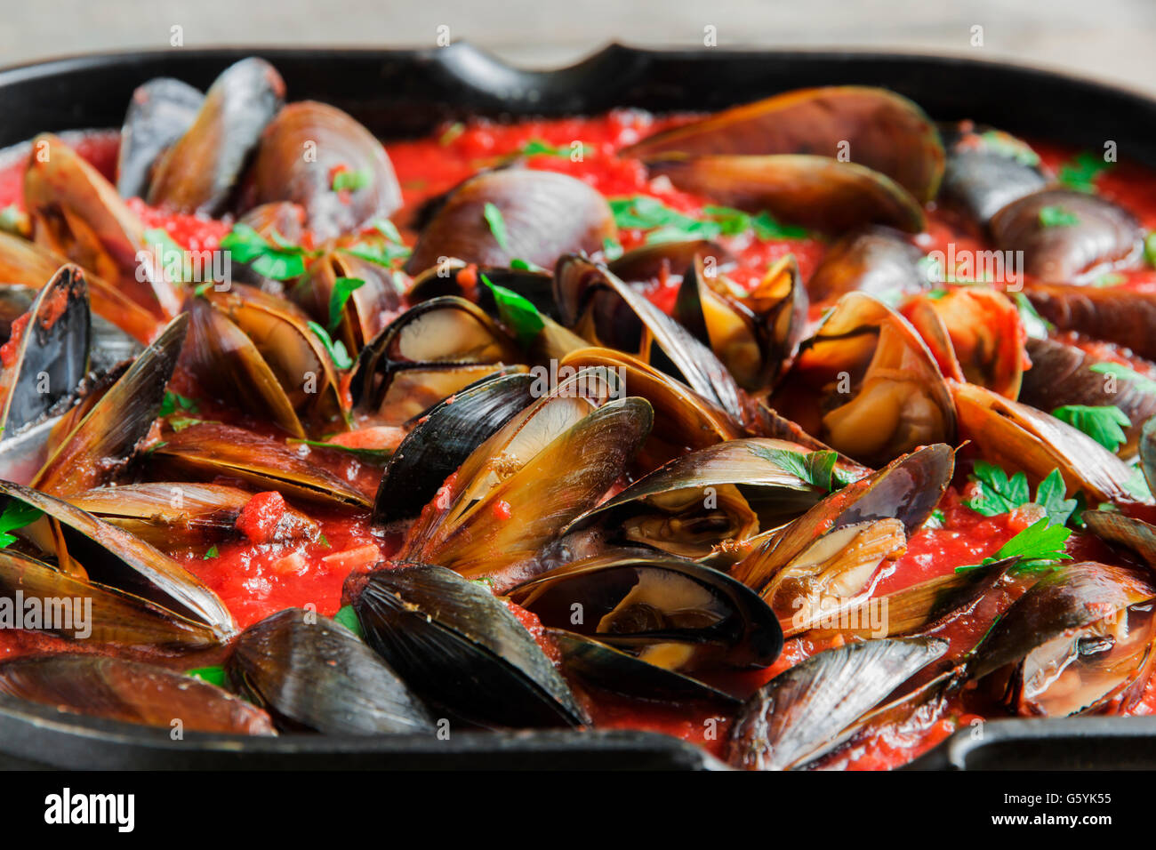 cooking mussel opens in tomato sauce Stock Photo Alamy