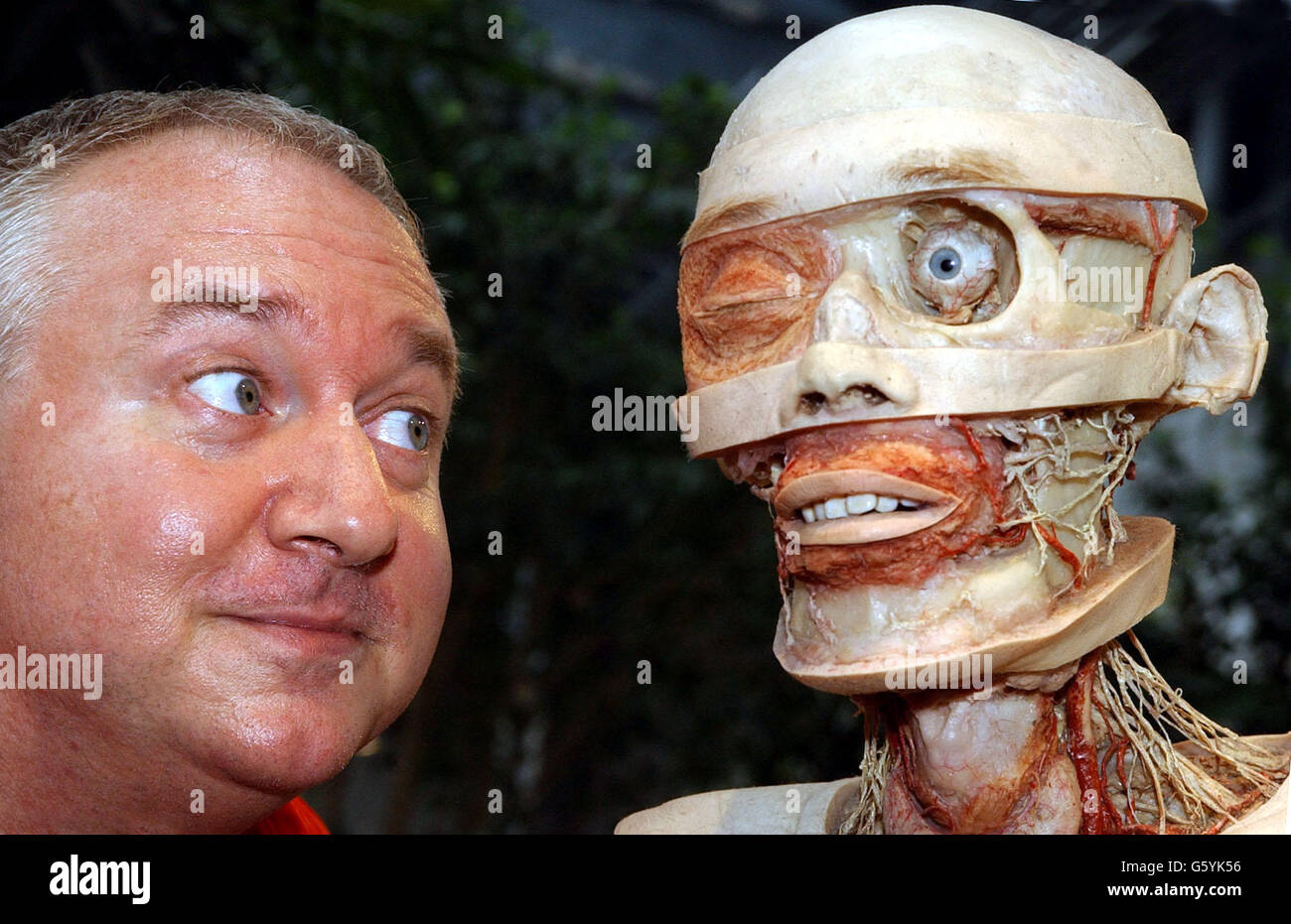 Raymond Edwards, 51, from Islington, London, who has decided to become a body donor picutred alongside a plastinate at the Body World's Exhibition at the Atlantis Gallery in Brick Lane, east London. *...A group of donors from around the country travelled to the gathering in London to come face to face with Professor Gunther von Hagens, the creator of the anatomical, show Body Worlds. See PA story ARTS Corpses. PA Photo: Kirsty Wigglesworth. Stock Photo